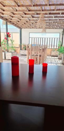 a table with two red cups on top of it at DARKOM in Dakhla