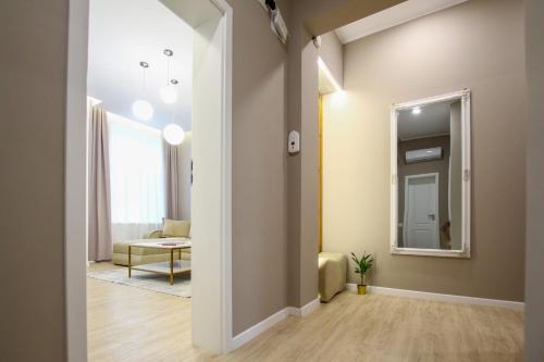 a hallway with a mirror and a living room at Mianelly Center in Constanţa