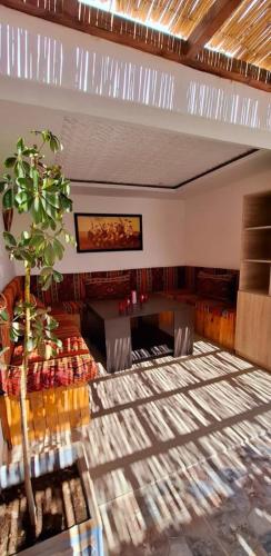 a room with a table and a tree in it at DARKOM in Dakhla