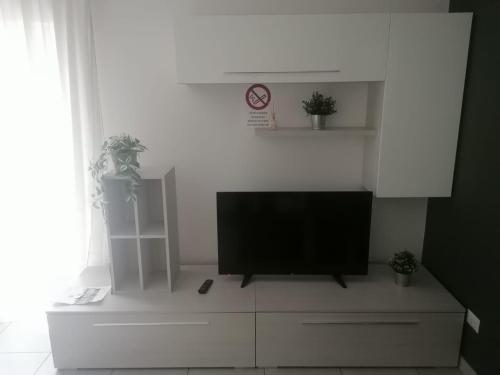 a flat screen tv sitting on top of a white cabinet at Happydays - Equipped Suite - Appartamento Intero in Randazzo