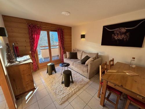 un salon avec un canapé et une table dans l'établissement Appartement cosy près des pistes avec garage, WIFI, terrasse - La Clusaz - FR-1-459-234, à La Clusaz
