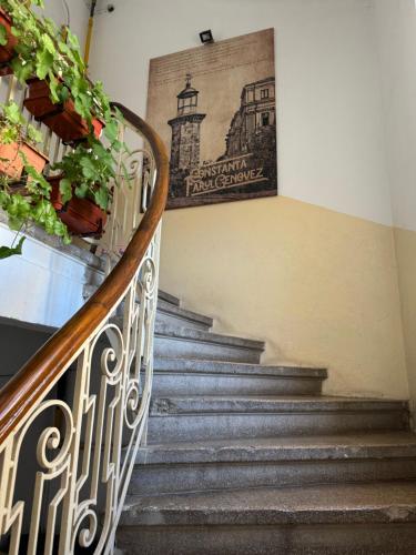 a set of stairs with a painting on the wall at Mianelly Center in Constanţa