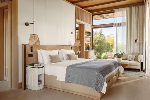 a bedroom with a large bed and a large window at One&Only Aesthesis, Athens in Athens