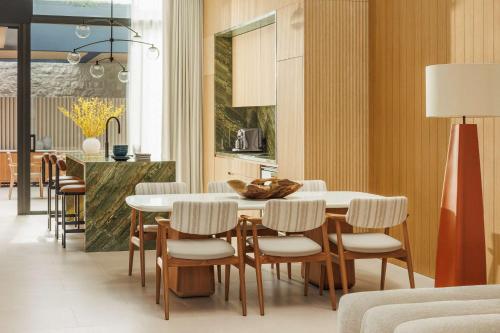 a kitchen and dining room with a table and chairs at One&Only Aesthesis, Athens in Athens