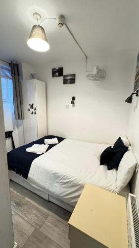 a bedroom with a bed and a table in it at Earl's Court Rooms in London