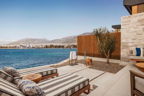 a patio with a view of the water at One&Only Aesthesis, Athens in Athens