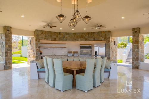 a dining room with a table and chairs at Spacious 5 Bd Villa Fully Staffed w Chauffeur in Puerto Los Cabos! in San José del Cabo