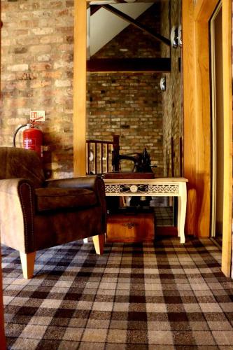 a living room with a couch and a table at The Pig Inn in Snaith