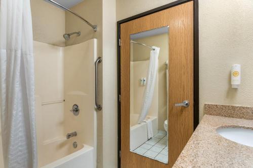 a bathroom with a shower and a sink at Comfort Inn & Suites Greeley in Greeley