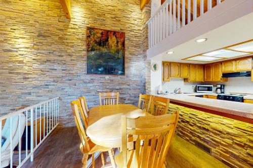 a dining room with a wooden table and a kitchen at Lake Village Townhouse B in Zephyr Cove
