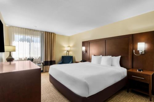 a large white bed in a hotel room at Comfort Inn & Suites Greeley in Greeley