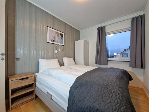 a bedroom with a large bed and a window at apartment With fantastic view and parking in Tromsø