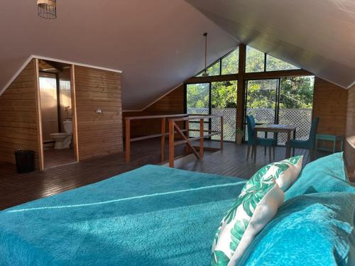 a person laying on a bed in a room at Casa Takarua in Hanga Roa