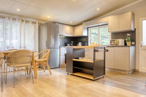 a kitchen and dining room with a table and chairs at Casa da Praia, a Home in Madeira in Tábua