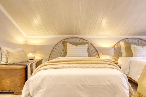a bedroom with two beds and two tables with lamps at Casa da Praia, a Home in Madeira in Ribeira Brava
