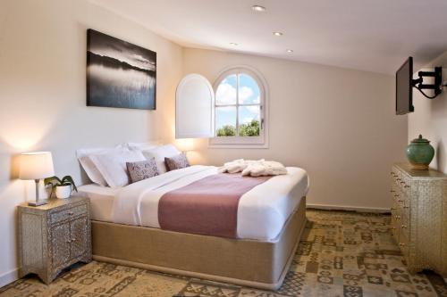 a bedroom with a large bed with a window at Boutique Hotel Can Pico in L'Escala