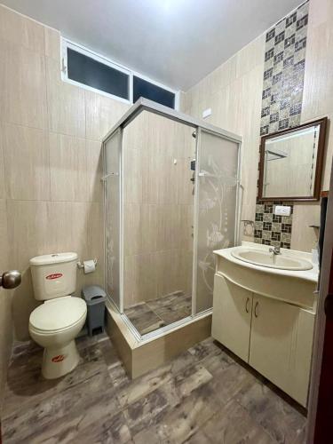 a bathroom with a shower and a toilet and a sink at Darwin's Hideaway in Puerto Baquerizo Moreno