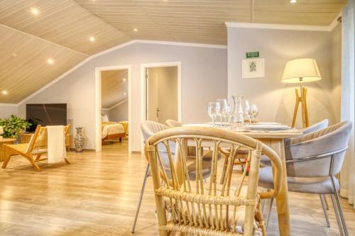 a dining room with a table and chairs at Casa da Praia, a Home in Madeira in Tábua