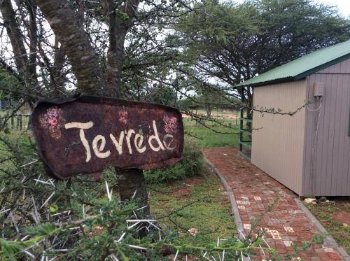 a sign that says revived sitting next to a tree at Klein Paradys Lodge - Polokwane in Polokwane