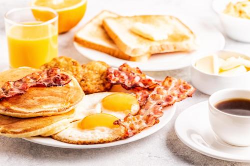 two plates of breakfast foods with eggs and toast at Renaissance Atlanta Midtown Hotel in Atlanta