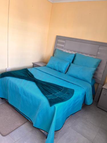 Ένα ή περισσότερα κρεβάτια σε δωμάτιο στο HavenNest Guest House
