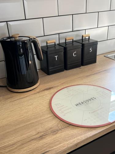 a counter with a coffee pot on a counter top at MOREaccom Maisonette in Morecambe