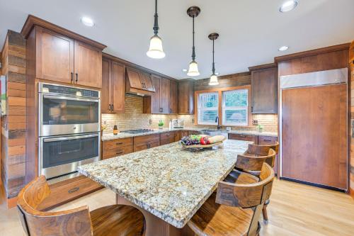 a kitchen with wooden cabinets and a table with a bowl of fruit at Gorgeous Home with Mt Rainier Views 4 Mi to Poulsbo in Poulsbo