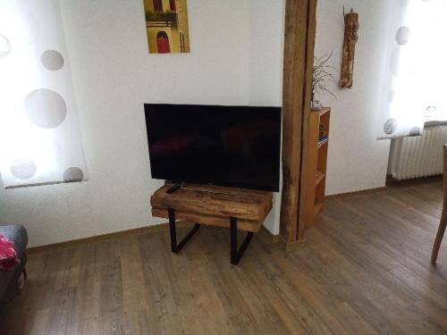 a flat screen tv sitting on a table in a living room at Im Hochparterre relaxen in Breitenbach am Herzberg