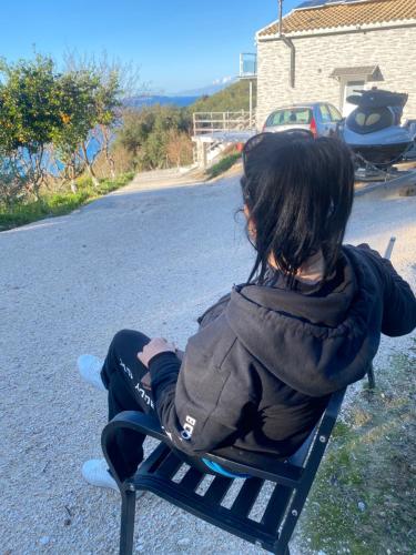 a young girl sitting on a bench on a skateboard at FRUIT Eco Villa in Avliótai