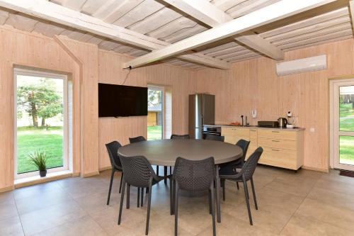 a kitchen and dining room with a table and chairs at Duriu sodyba in Molėtai