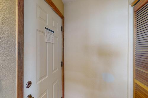 a white door in a room with a window at Wildernest Gore Trail Condo in Silverthorne