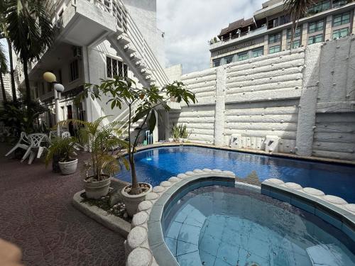 a large swimming pool in the middle of a building at Kandi Suites 2BR with private Jacuzzi 500 Mbps internet in Angeles
