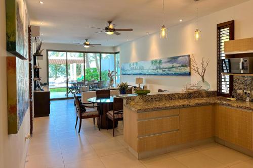 a kitchen with a table and a dining room at Kasos ground level apartment in Chicxulub