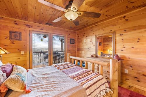 a bedroom with a bed and a ceiling fan at Above and Beyond, Cabin with Massive Views Near Helen in Cleveland