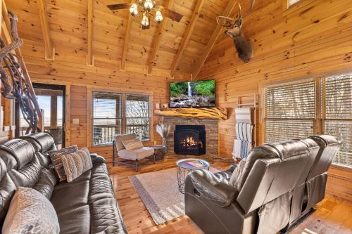 a living room with leather furniture and a fireplace at Above and Beyond, Cabin with Massive Views Near Helen in Cleveland