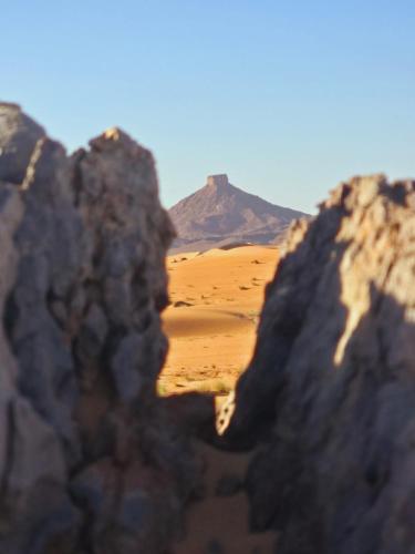 a view of a desert with a mountain in the background at Riad Ouzina TGM in Ouzina