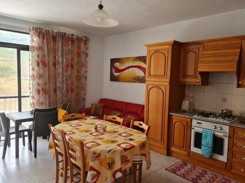 a kitchen and dining room with a table and a table and chairs at Charming Seaside Apartment in Mellieħa