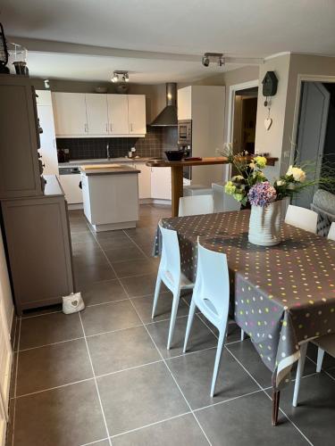 une cuisine et une salle à manger avec une table et des chaises dans l'établissement Charmante maison de centre ville 8pers, à Perros-Guirec