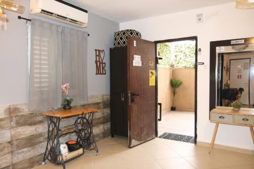 a room with a door and a table and a table at The Private House רשת הבית הפרטי in Beer Sheva