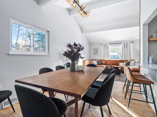 a dining room with a table and chairs at Two Entire Homes with Hot Tubs and Games Sleeps 20 in Akron