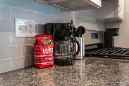a kitchen counter with a coffee maker on a counter top at Bubba and Banjos in Lewes