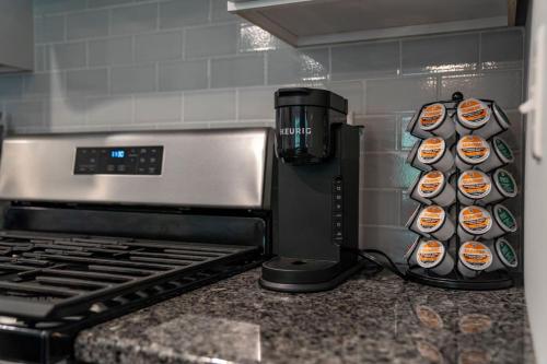 a kitchen counter with a coffee maker next to a stove at Bubba and Banjos in Lewes