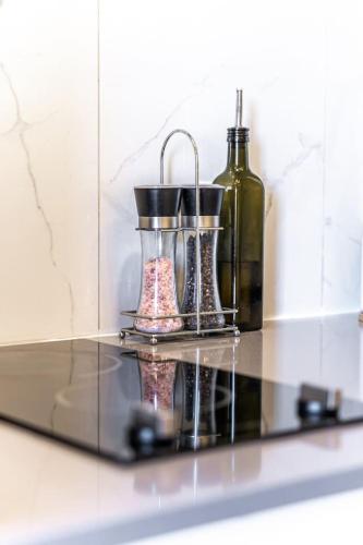 a glass shelf with two bottles on it in a bathroom at MR Loft formerly The Lehman Studio Stratford in Stratford