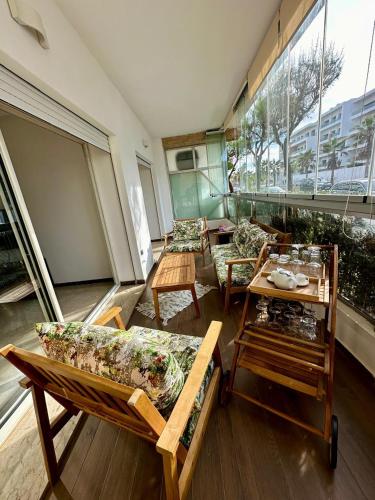 a room with couches and tables in a building at Peninsula Dar Bouazza in Tamaris