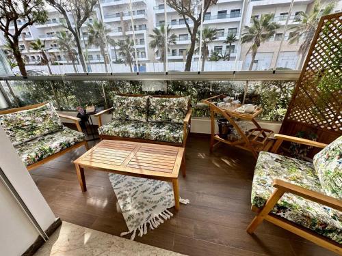 a balcony with chairs and a table on a building at Peninsula Dar Bouazza in Tamaris