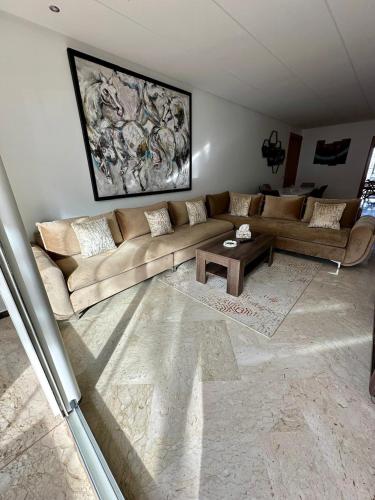 a living room with a couch and a coffee table at Peninsula Dar Bouazza in Tamaris