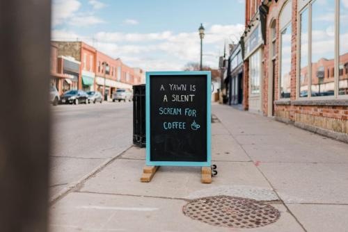 a chalkboard sign sitting on the side of a street at The Wallace Suite - Stratford in Stratford
