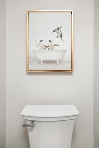 a picture of two birds in a bath tub above a toilet at Cedar Peak Condo - Downtown Sevierville in Sevierville