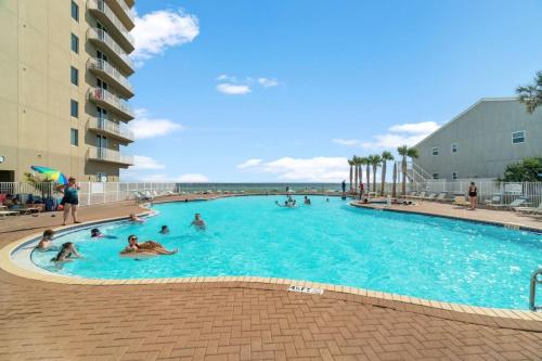 a group of people in a large swimming pool at Family-Friendly Gulf-Front Condo w/Beach Access in Panama City Beach