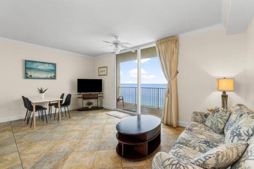 a living room with a couch and a table at 20th-floor condo with Gulf views, resort amenities & 2 lagoon-style pools in Panama City Beach